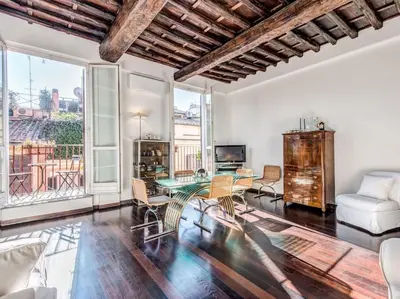 a living room with a table and chairs at Luxury Spanish Steps Terrace in Rome