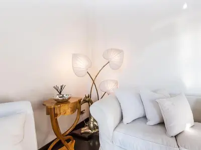 a living room with a white couch and a table at Luxury Spanish Steps Terrace in Rome