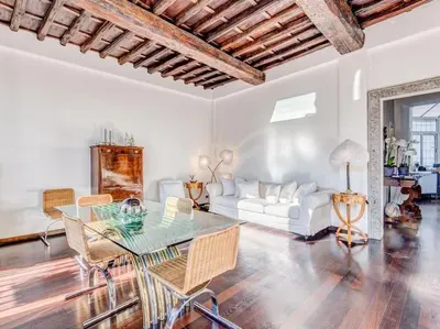 a living room with a table and a white couch at Luxury Spanish Steps Terrace in Rome