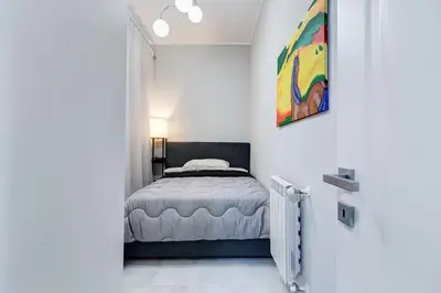 a bedroom with a bed and a painting on the wall at Vatican Escape in Rome
