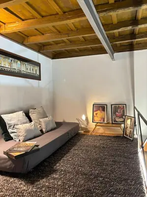 a living room with a bed in a room at La Dimora a Roma antica in Rome