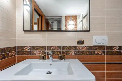 a bathroom with a white sink and a mirror at Elegantis Purificazione Suite Apartment in Rome
