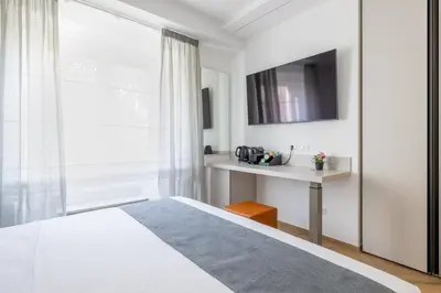 a bedroom with a white bed and a window at Hezio Guest House in Rome