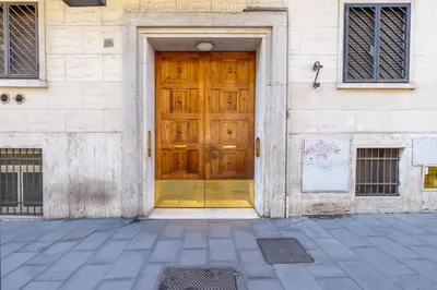a wooden door on the side of a building at Hezio Guest House in Rome