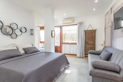 a bedroom with a bed and a couch at Spacious 4 BDR with Parking in Rome