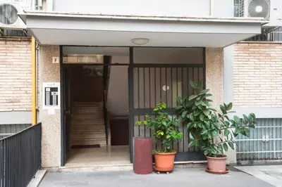 a front door of a house with two plants at Appartamento tra Piramide e Garbatella - Urbe Romana in Rome