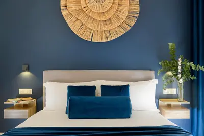 a blue bedroom with a bed with a blue wall at Tolu Relais in Rome