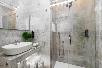 a bathroom with a sink and a shower at Tolu Relais in Rome