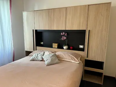 a bedroom with a large bed with a headboard at StazioneSanPietro53 in Rome