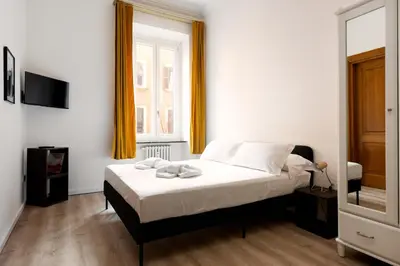 a bedroom with a bed and a window at Confalonieri Place by Oneup Hospitality in Rome