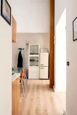 a kitchen with a counter and a refrigerator at Confalonieri Place by Oneup Hospitality in Rome