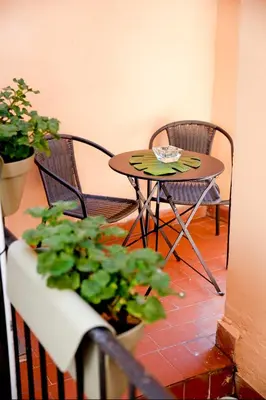 a small table and chairs and a table with plants at Monti Suite with charming Terrace in Rome