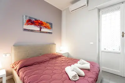 a bedroom with a bed with two towels on it at MagicHouse 2 Camere 2 Bagni -15 min Colosseo in Rome