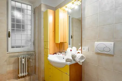 a bathroom with a sink and a mirror at MagicHouse 2 Camere 2 Bagni -15 min Colosseo in Rome