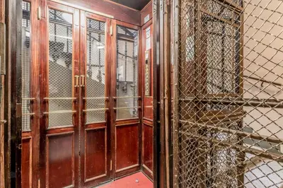 an empty room with wooden doors and windows at Roman Holiday Repubblica in Rome