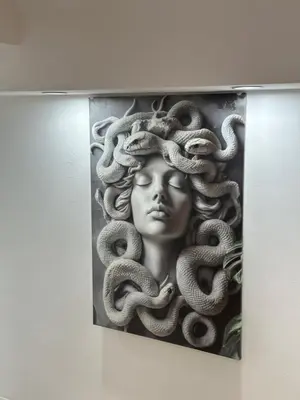 a statue of a woman with snakes on her head at IMPERIAL suite COLOSSEUM in Rome