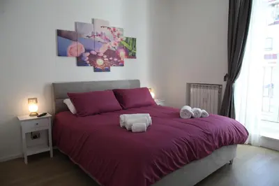 a bedroom with a purple bed with towels on it at MGFCandia111 - Appartamento al Vaticano in Rome
