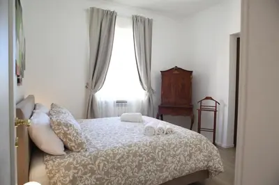 a bedroom with a bed with two towels on it at MGFCandia111 - Appartamento al Vaticano in Rome