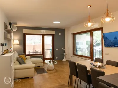 a living room with a table and a couch at DeaSuites One in Rome