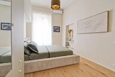 a bedroom with a bed in a room with a mirror at Boncompagni79 design & comfort in the City Center Villa Borghese in Rome