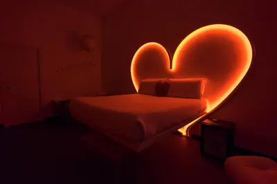 a bedroom with a heart shaped bed in the dark at Magenta Campo dei Fiori in Rome