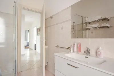 a white bathroom with a sink and a mirror at Francis house in Rome