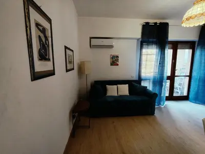 a living room with a couch and a window at Gemelli-St Peter Sweet House in Rome