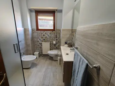 a bathroom with a sink and a toilet and a window at Gemelli-St Peter Sweet House in Rome