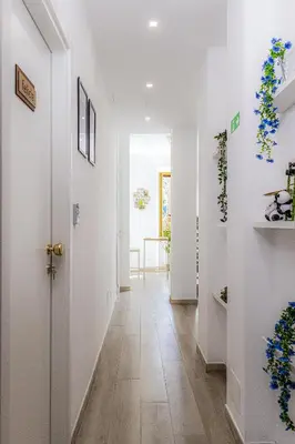 a hallway with white walls and a white door at Green Garden in Rome