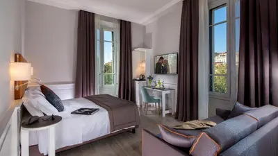 a hotel room with a bed and a couch at Princeps Boutique Hotel in Rome