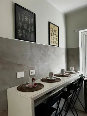 a kitchen with a counter with three plates and cups at Domus Romae in Rome