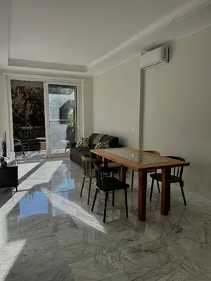 a living room with a wooden table and chairs at Domus Romae in Rome