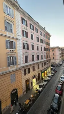 a street with cars parked in front of a building at Casa dolce Casa Trastevere in Rome