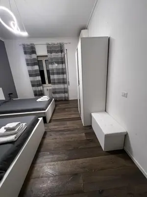 a room with two beds and a refrigerator at Monteverde COME a casa -HOME- in Rome