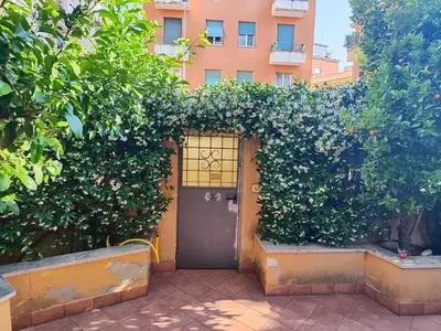 a door in a hedge with a building in the background at Casa Cartoni in Rome