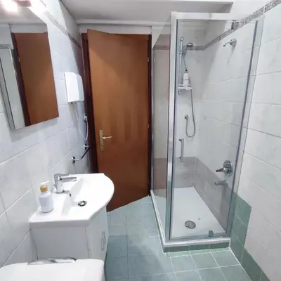 a bathroom with a shower and a toilet and a sink at Casa Cartoni in Rome