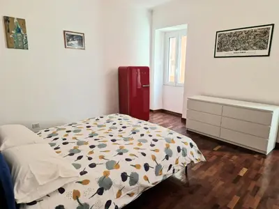 a bedroom with a bed and a dresser and a window at appartamento monticiano in Rome