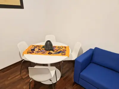 a table with a cat on it next to a blue couch at appartamento monticiano in Rome