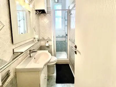 a white bathroom with a sink and a toilet at Home Roma Testaccio in Rome