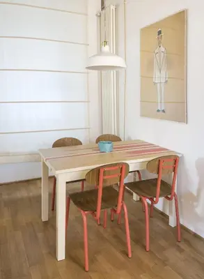 a dining room table with two chairs and a painting at Il Mandorlo a Monti in Rome