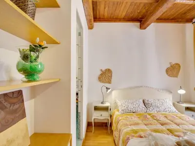a bedroom with a bed and a vase on a shelf at Il Mandorlo a Monti in Rome