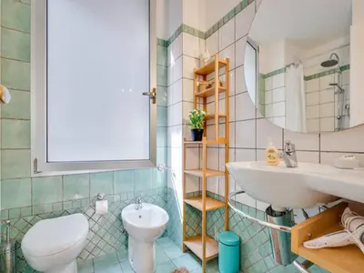 a bathroom with a sink and a toilet and a mirror at Il Mandorlo a Monti in Rome
