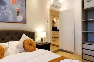 a bedroom with a bed and a painting on the wall at Vaticano Appartamento Suite Roma Centro Aura D4 in Rome
