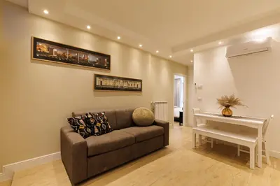 a living room with a couch and a table at Vaticano Appartamento Suite Roma Centro Aura D4 in Rome