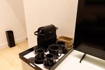 a tray with four coffee cups on a table at Vaticano Appartamento Suite Roma Centro Aura D4 in Rome