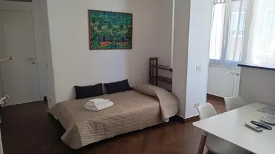 a small bedroom with a bed and a table at Appartamento moderno con vista sul verde 2 fermate da San Pietro in Rome