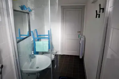 a bathroom with a sink and a mirror at Heartwarming Apartment in ROMA - 5 Minutes from Colosseum in Rome