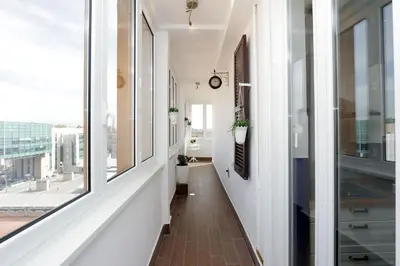 a hallway with white walls and large windows at Bright Vatican 2 bedroom Apartment in Rome