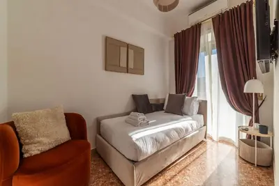 a bedroom with a bed and a tv on the wall at Casa Incanto - Luxury Vatican Apartment in Rome
