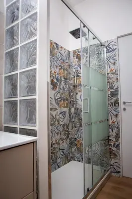 a bathroom with a shower with glass doors at Ostiense 73 in Rome